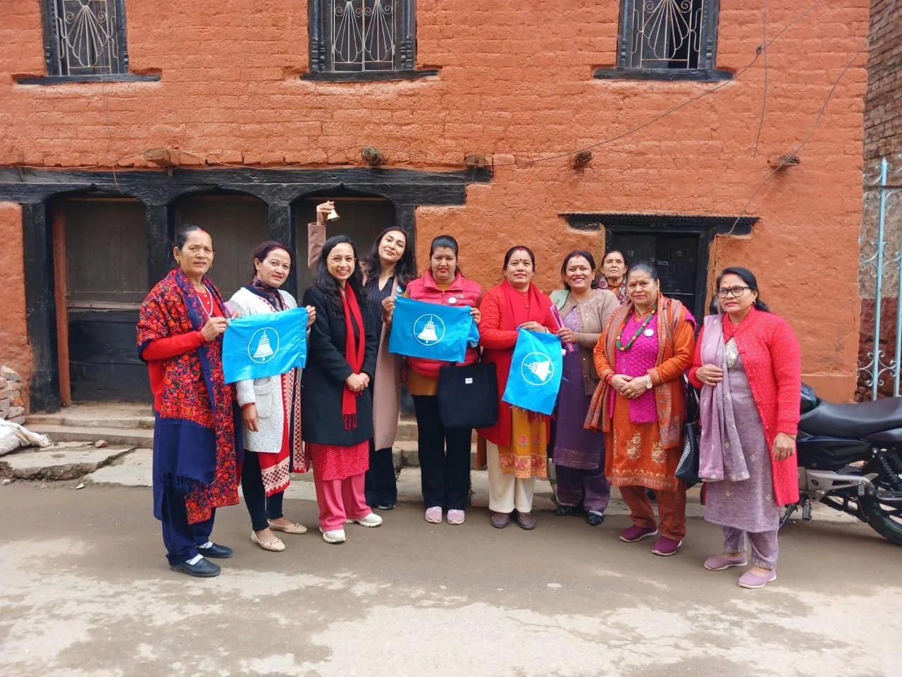 Anushka Shrestha distributing bags to local women